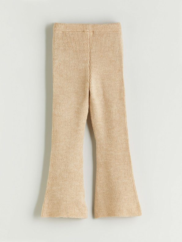 Three-piece set consisting of trousers, a blouse, and a knitted jacket